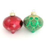 Christmas decorations : two glass baubles one green the other burgundy.