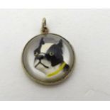 A pendant / charm set with an Essex Crystal cabochon with French Bulldog decoration within a white
