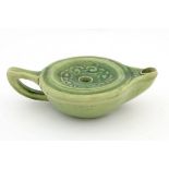 A Liberty London green glazed Arts and Crafts pottery oil lamp,