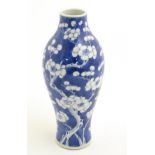 A Chinese blue and white vase decorated with prunus, Chinese character marks to base. Approx.