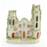 A Staffordshire pottery pastille burner in the form of a castle with floral decoration. Approx.