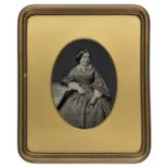 *Whole-plate ambrotype, 1850s, of a seated lady, photographer unknown, 19.5 x 14cm, oval gilded