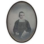 *Daguerreotype. A quarter-plate daguerreotype of a priest, 1845, half length, seated and holding