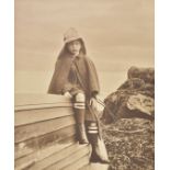 *Sutcliffe (Frank Meadow, follower of). Young boy in sou'wester sitting on an upturned boat, c.