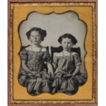 *Sixth-plate ambrotype of two little girls seated and holding hands, by an unknown photographer,