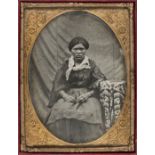 *Ambrotype. An ethnographic portrait of a woman seated at a table, c. 1860s, quarter plate, oval