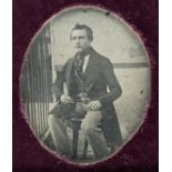 *Sixth-plate daguerreotype of a young man seated outdoors next to railings, by an unknown