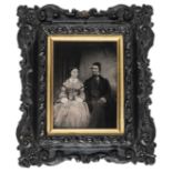 *Half-plate ambrotype of a husband and wife, 1850s, tinted, 13 x 9.5cm, wood and plaster frame