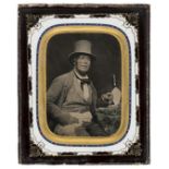 *Ambrotype. A half-plate tinted ambrotype of a mason or architect, 1850s, half length and seated,