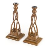 *Candlesticks. Pair of Arts & Crafts oak candlesticks, each with spiral open twist stems on square