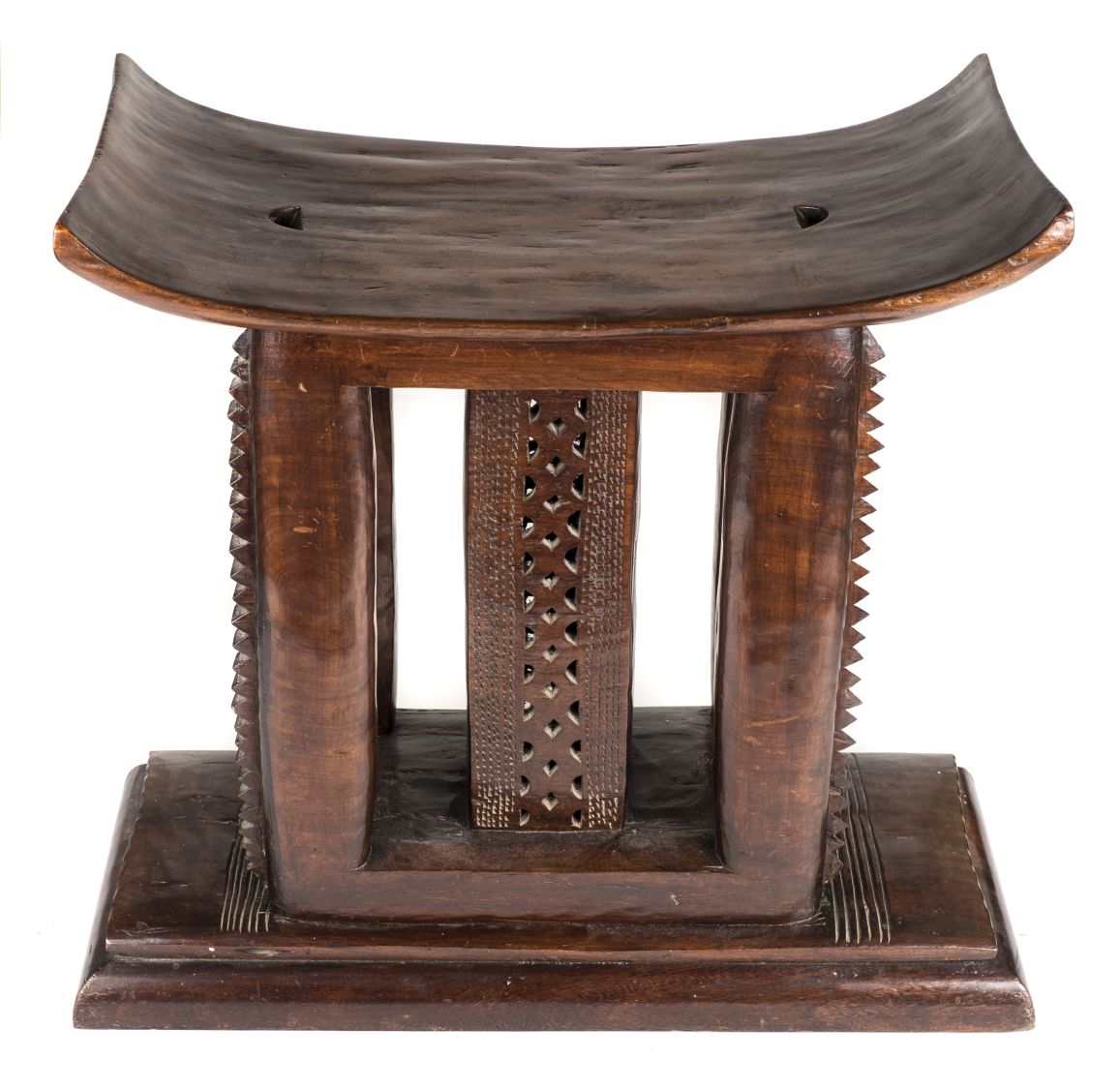 *Stool. Ashanti chief's hardwood stool, with curved seat on carved supports and substantial base