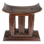 *Stool. Ashanti chief's hardwood stool, with curved seat on carved supports and substantial base