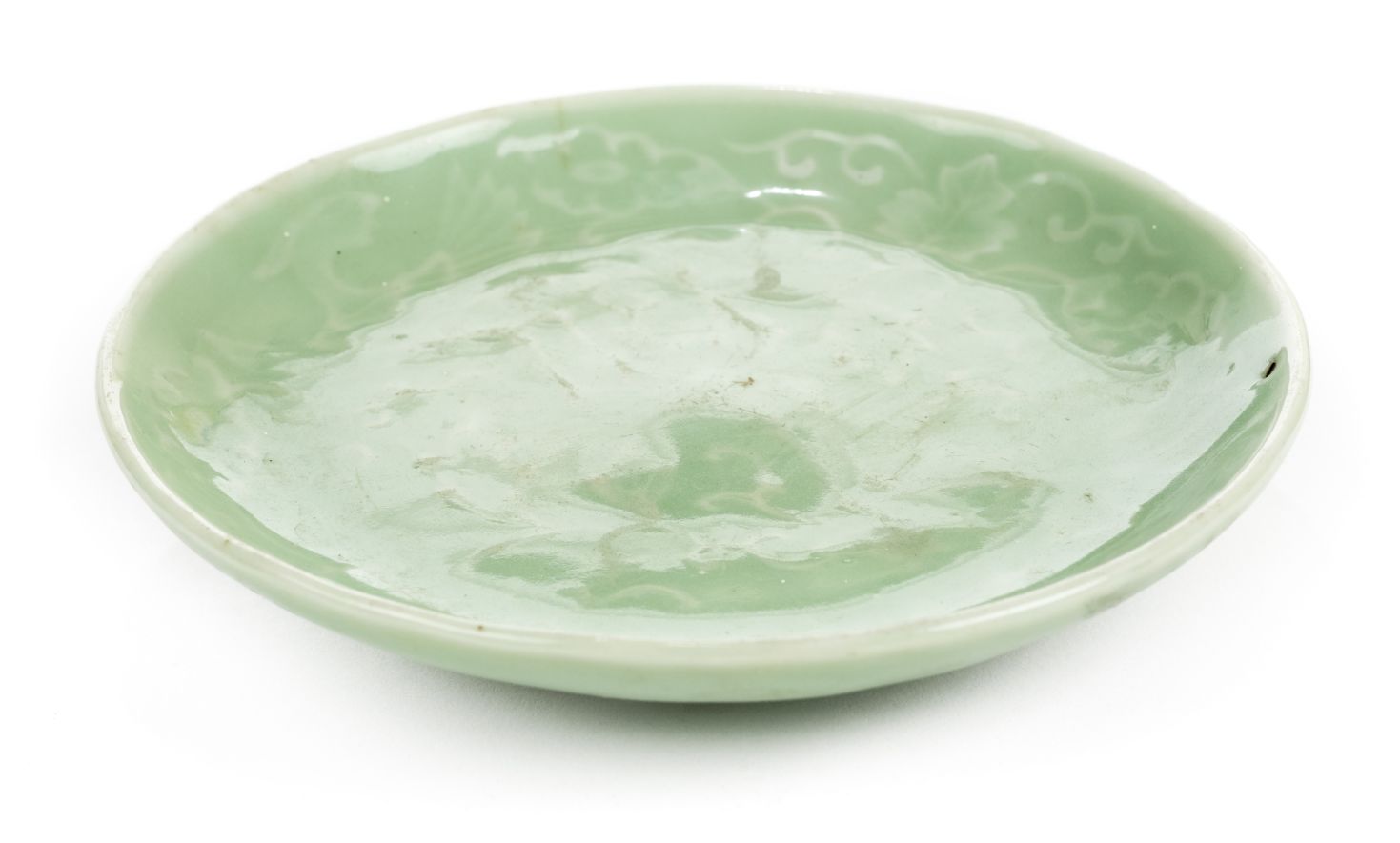 *Dish. A Chinese celadon porcelain dish, with raised decoration of a bird within foliage, blue 5