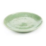 *Dish. A Chinese celadon porcelain dish, with raised decoration of a bird within foliage, blue 5