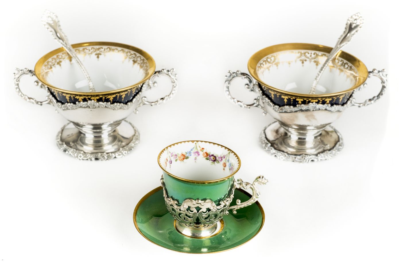 *Dresden. Set of six porcelain bowls, each richly gilded on a blue ground supported in twin handle