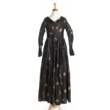 *Dress. A brocade gown, circa 1840s, hand-sewn dress of black brocade with woven rose sprays in