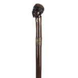 *Walking Stick. 19th century walking stick, the knop carved as a Negro wearing a tasselled hat