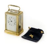 *Carriage Clock. A 20th century brass carriage clock, the white enamel dial with black roman