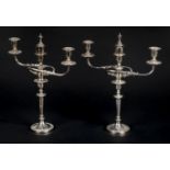 *Candelabras. A pair of Edwardian silver plated three branch candelabras, each with central urn