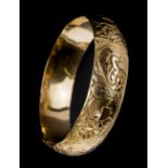 *Bangle. 14K gold bangle, engraved with floral design, stamped 14K, approximately 22g (1)