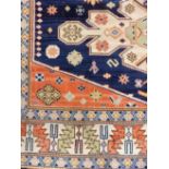 *Carpet. Modern woollen Kashmir carpet, with 4 medallions on a blue ground within multibanded