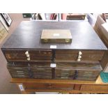 *Blocking die letters. Two wooden type cabinets containing a selection of brass blocking die