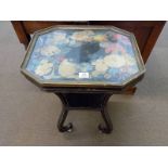*Table. Victorian ebonized and gilt occasional table, the octagonal glass top inset with foliate