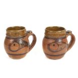 *Cardew (Seth, 1934-). Pair of pottery mugs, decorated with fish on a mixed brown ground, seal