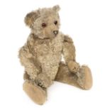 *Teddy. A teddy bear in the Steiff style, early 20th century, a jointed light brown mohair teddy