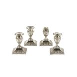 FOUR EDWARDIAN ADAM STYLE CANDLESTICKS