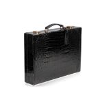 A BLACK CROCODILE BRIEF CASE, RETAILED BY LIBERTY OF LONDON