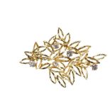 A DIAMOND AND GOLD FOLIATE BROOCH