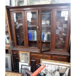 A LATE VICTORIAN WALNUT LIBRARY BOOKCASE with four glazed upper doors and an arrangement of