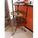 A GEORGE III MAHOGANY THREE TIER DUMB WAITER, with three revolving circular shelves above a tripod