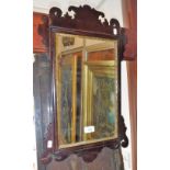 A GEORGE III MAHOGANY FRAMED WALL MIRROR, 24" high