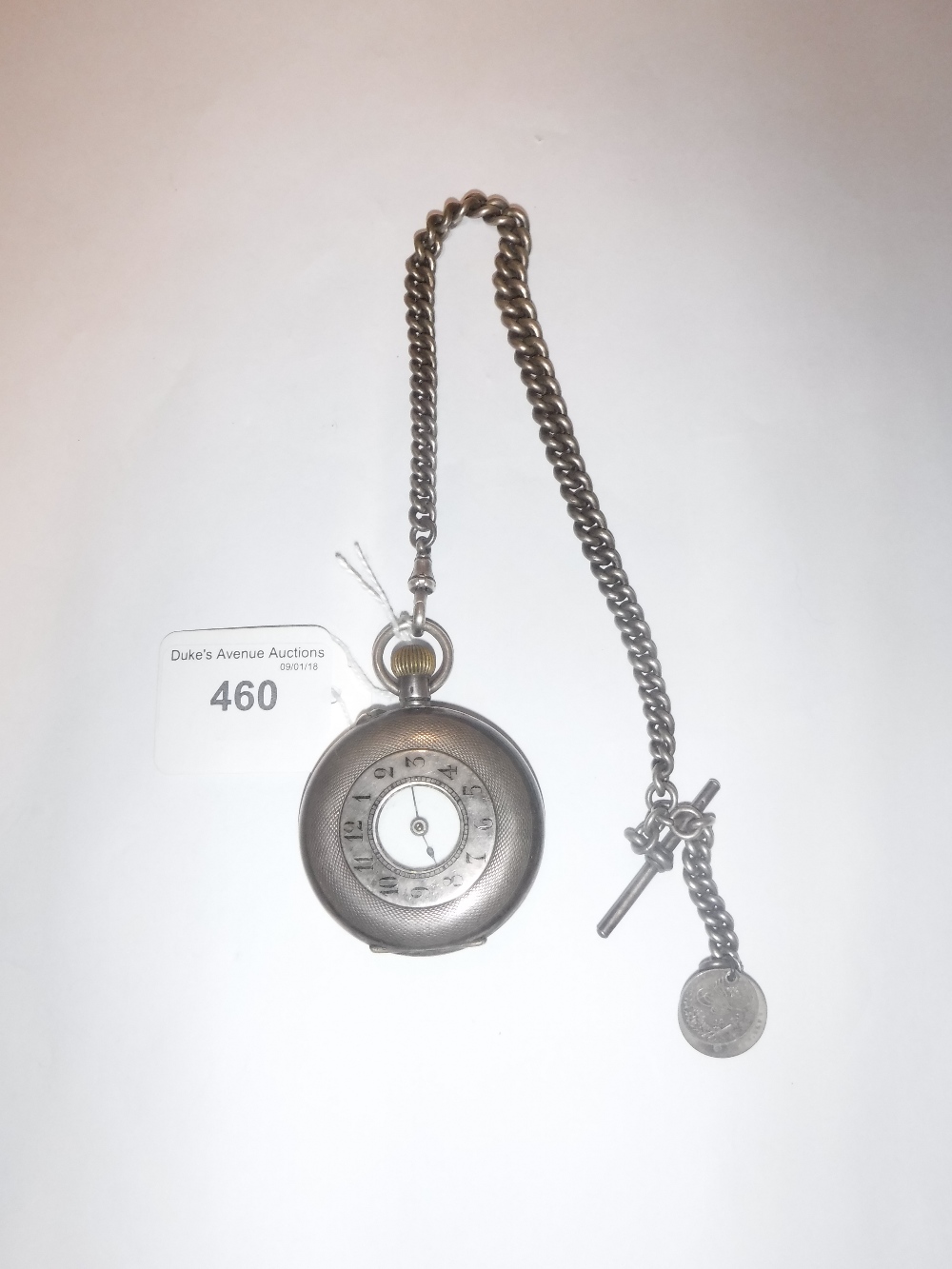 A GENTLEMAN'S SILVER HALF HUNTER POCKET WATCH with enamel dial on a silver curb link watch chain