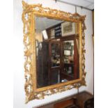 A LARGE GILTWOOD WALL MIRROR with carved acanthus decoration, 51" high x 44" wide