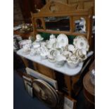 A VICTORIAN ASH WASHSTAND with a white marble top and green tiled and mirrored back, 42" wide