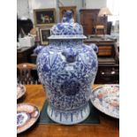 A LARGE REPRODUCTION CHINESE BLUE AND WHITE JAR AND COVER with all over hand painted decoration