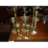 A PAIR OF ROCOCO BRASS CANDLESTICKS, a pair of brass spiral candlesticks and two other pairs