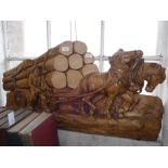 A WOOD CARVING OF A LUMBERJACK and two Shire horses pulling a wagon of tree stumps, 4" wide