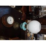 AN EARLY 20TH CENTURY WALL BAROMETER in a carved wood case and an oil lamp (2)