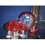 A SET OF FOUR CRANBERRY GLASS BEAKERS and a set of six cranberry and clear glass glasses and a