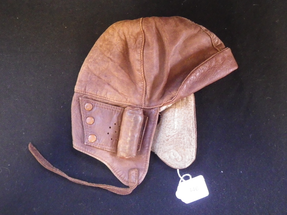 A VINTAGE "GROSSE" BROWN LEATHER MOTOR CYCLE OR MOTORING HELMET