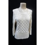 A CREAM 'BAT-WING' KNITTED JUMPER, the waistline, sleeves and neckline with crocheted detail