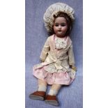 AN EARLY 20TH CENTURY DOLL with a ceramic head stamped "1908 DEP W&Co 121 AM 5" with composite