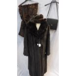 A FULL LENGTH DARK BROWN FUR COAT, a fur cape, fur trimmed hat and a skin handbag