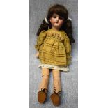 AN EARLY 20TH CENTURY DOLL with a ceramic head, stamped "Made in Germany 390 A.3.M.", with a