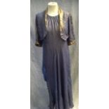 A BLUE AND GOLD LUREX EVENING DRESS, the back with chiffon flowing ties and a matching bolero