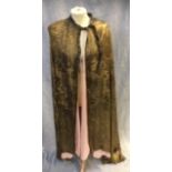 A VINTAGE GOLD LUREX EVENING CAPE, embossed with flowers and pink lining